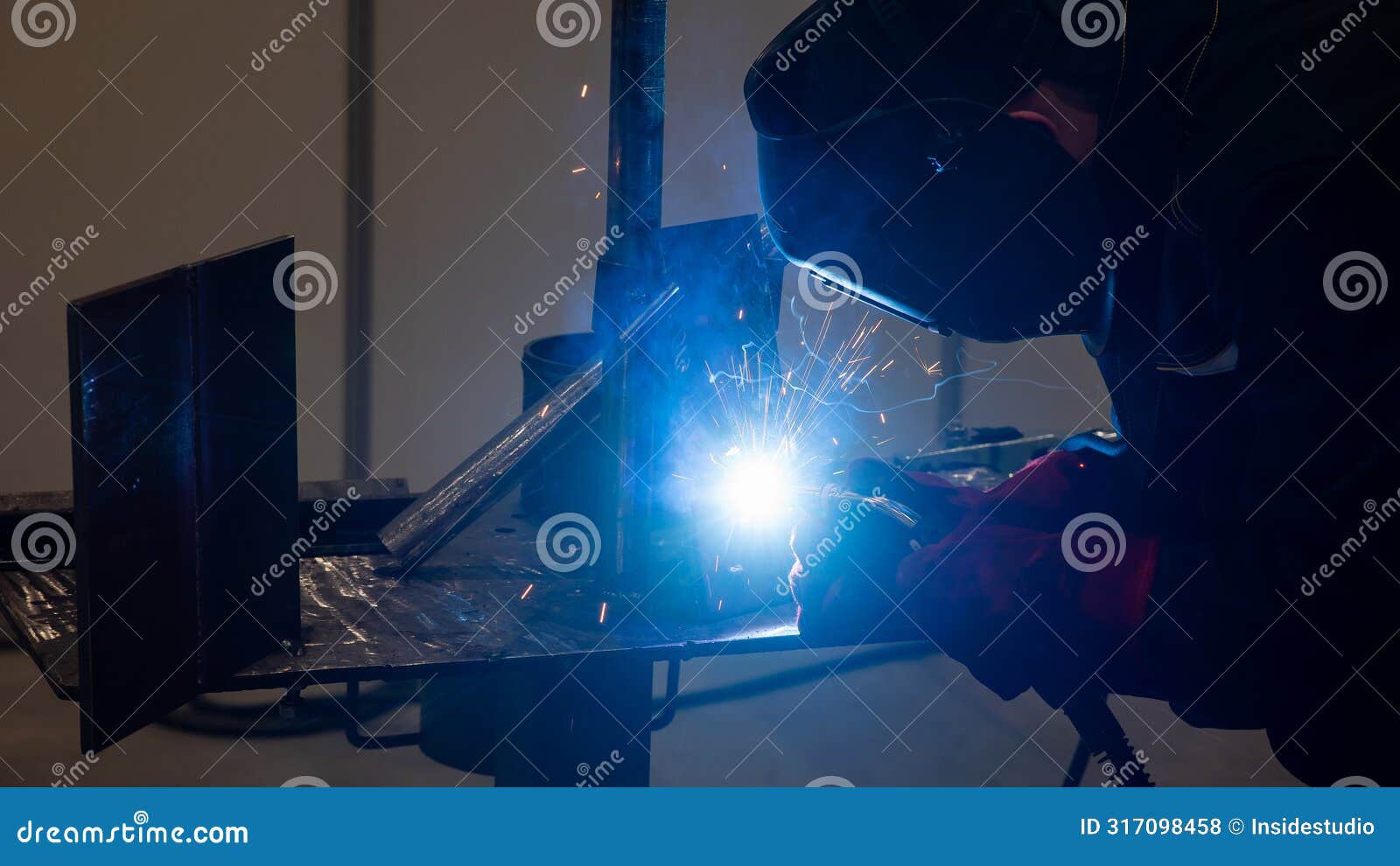 competitions among welders. a man in a protective mask is welding.