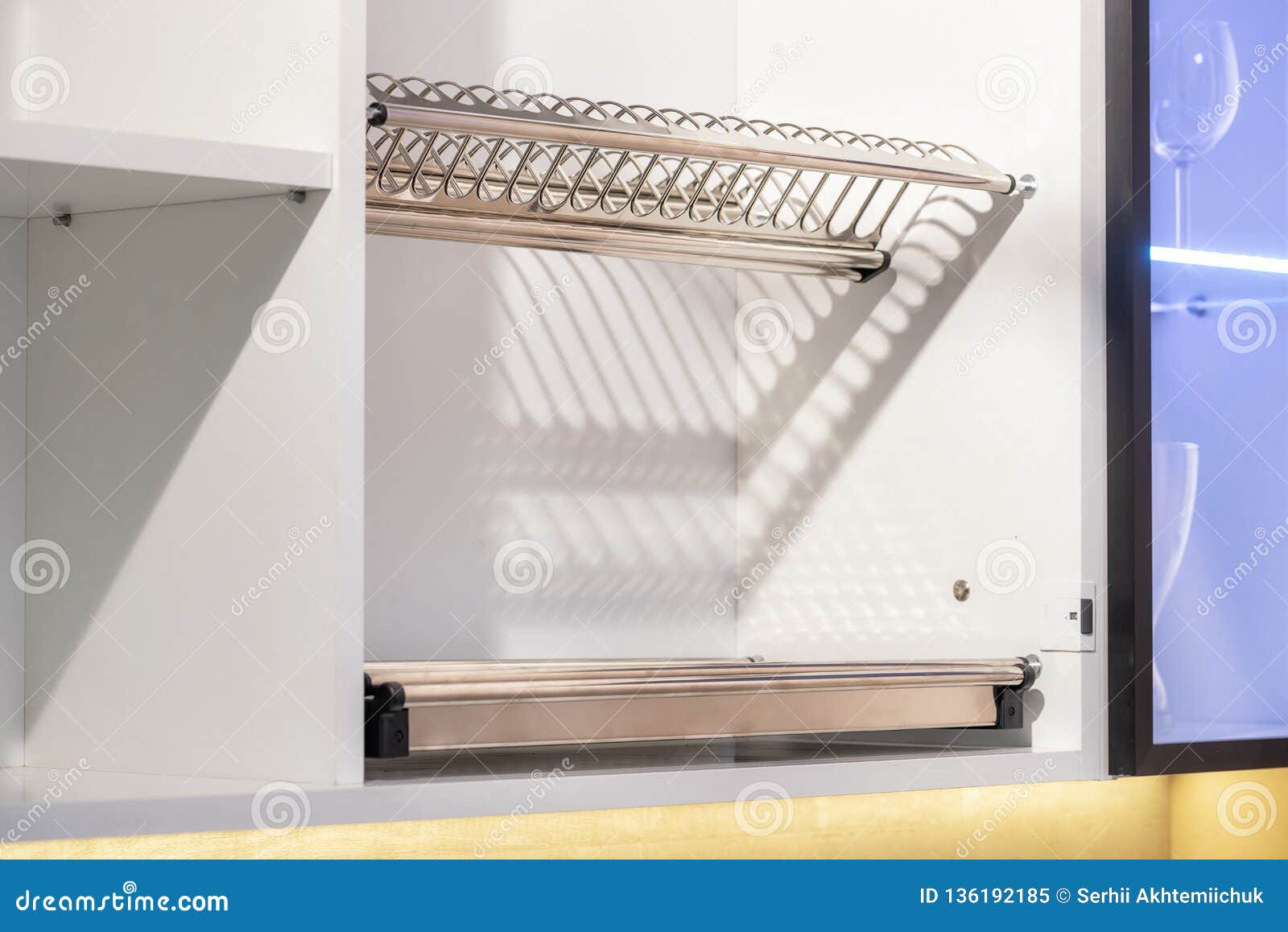 Completely Opened White Kitchen with Plates and Glasses on