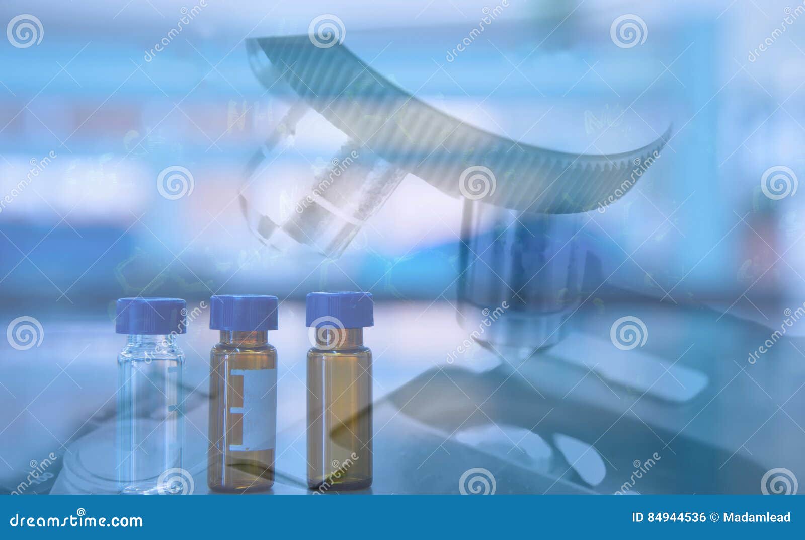 Compond Microscope and Syringe in Scientist Hand in Science Labboratory