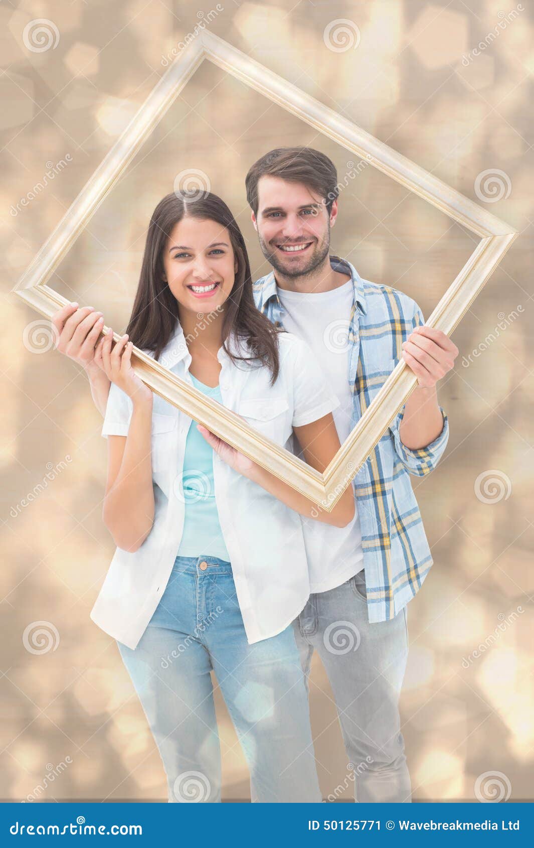 Composite Image of Happy Young Couple Holding Picture Frame Stock Image