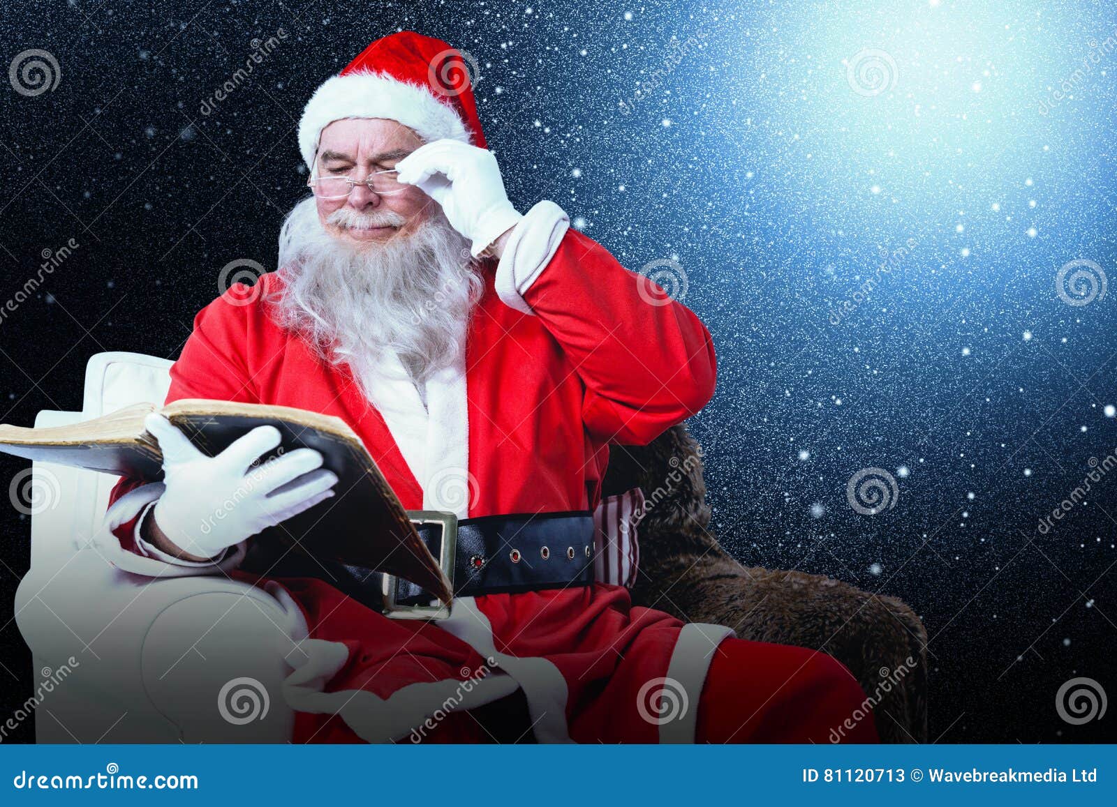 Composite Image of Santa Claus Reading Bible on Armchair Stock Image