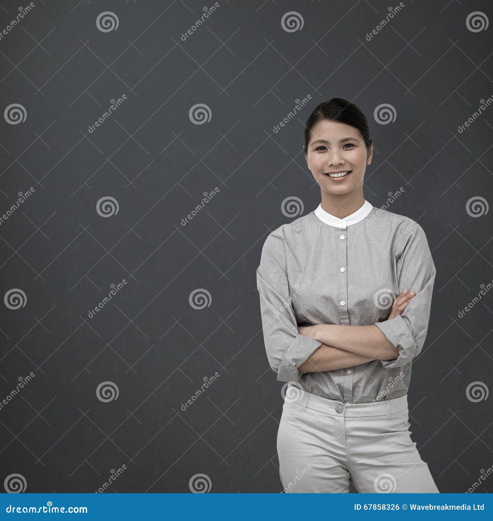 composite image of selfassured businesswoman with folded arms