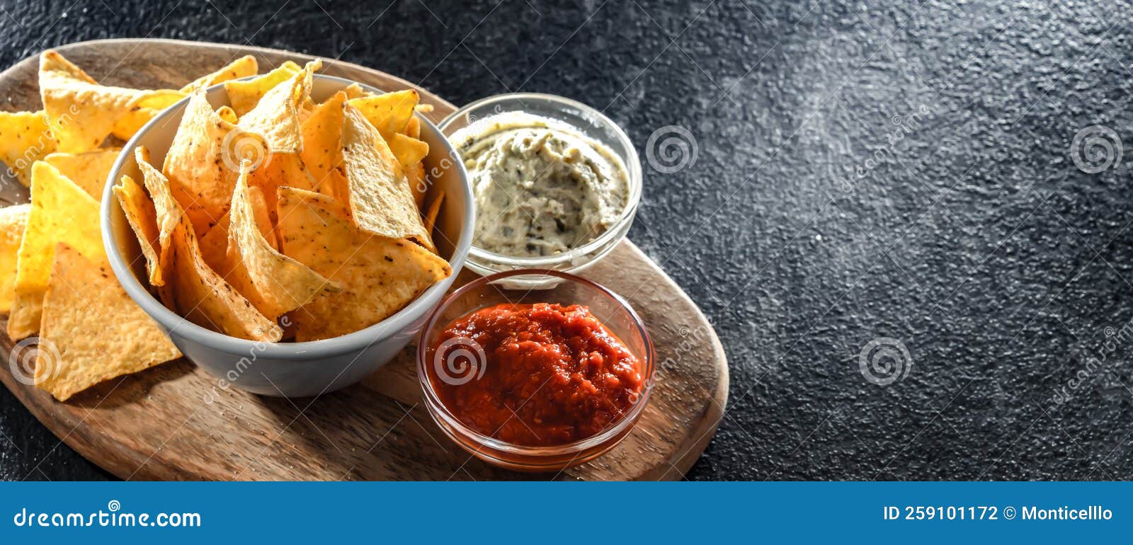 Composition with a Bowl of Tortilla Chips and Dipping Sauces Stock