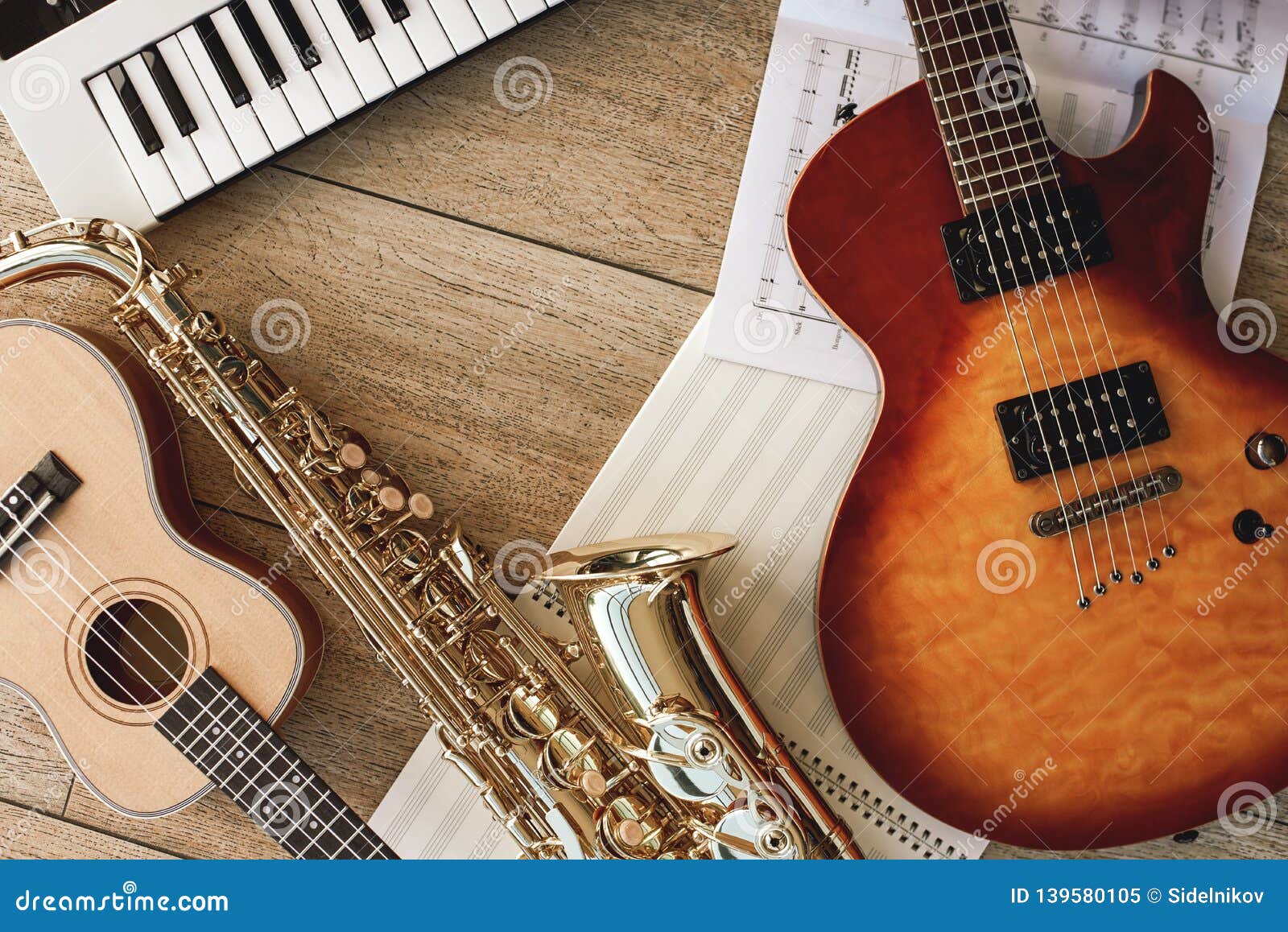 Composition of Different Musical Instruments: Synthesizer, Electronic  Guitar, Saxophone and Ukulele Lying, Sheets with Stock Image - Image of  musician, percussion: 139580105