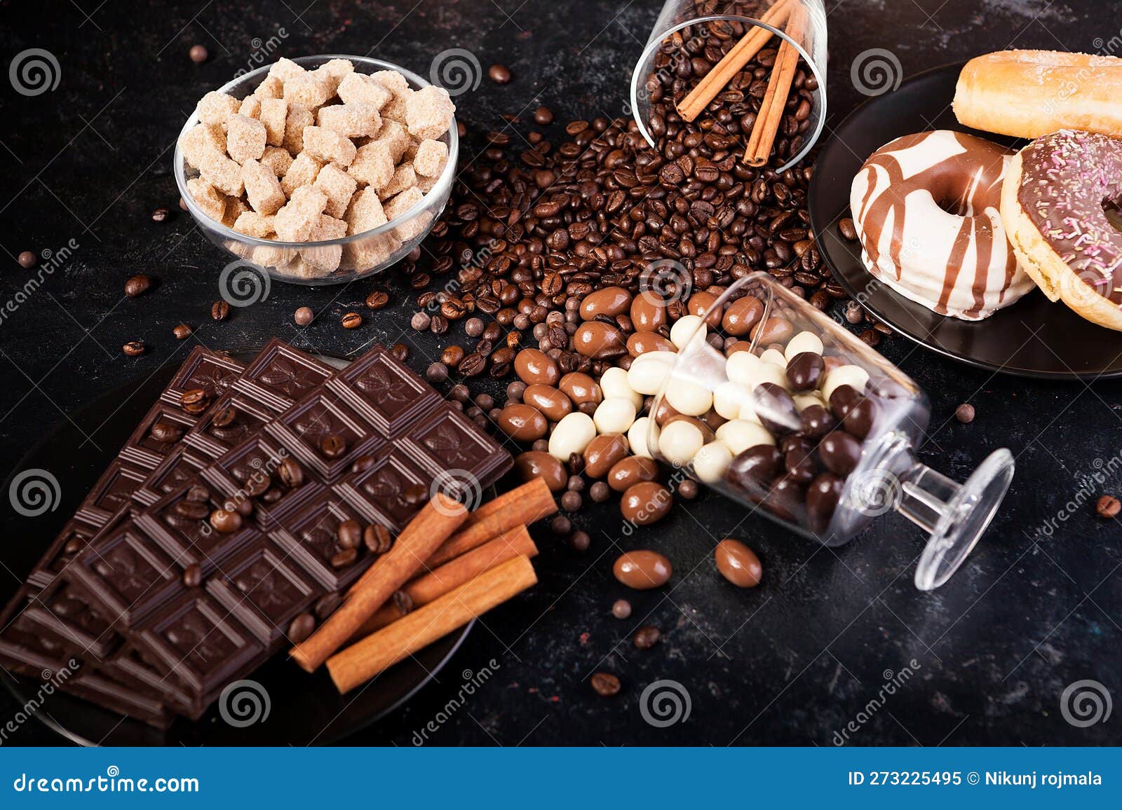 composition from different type of candies on dark wooden background