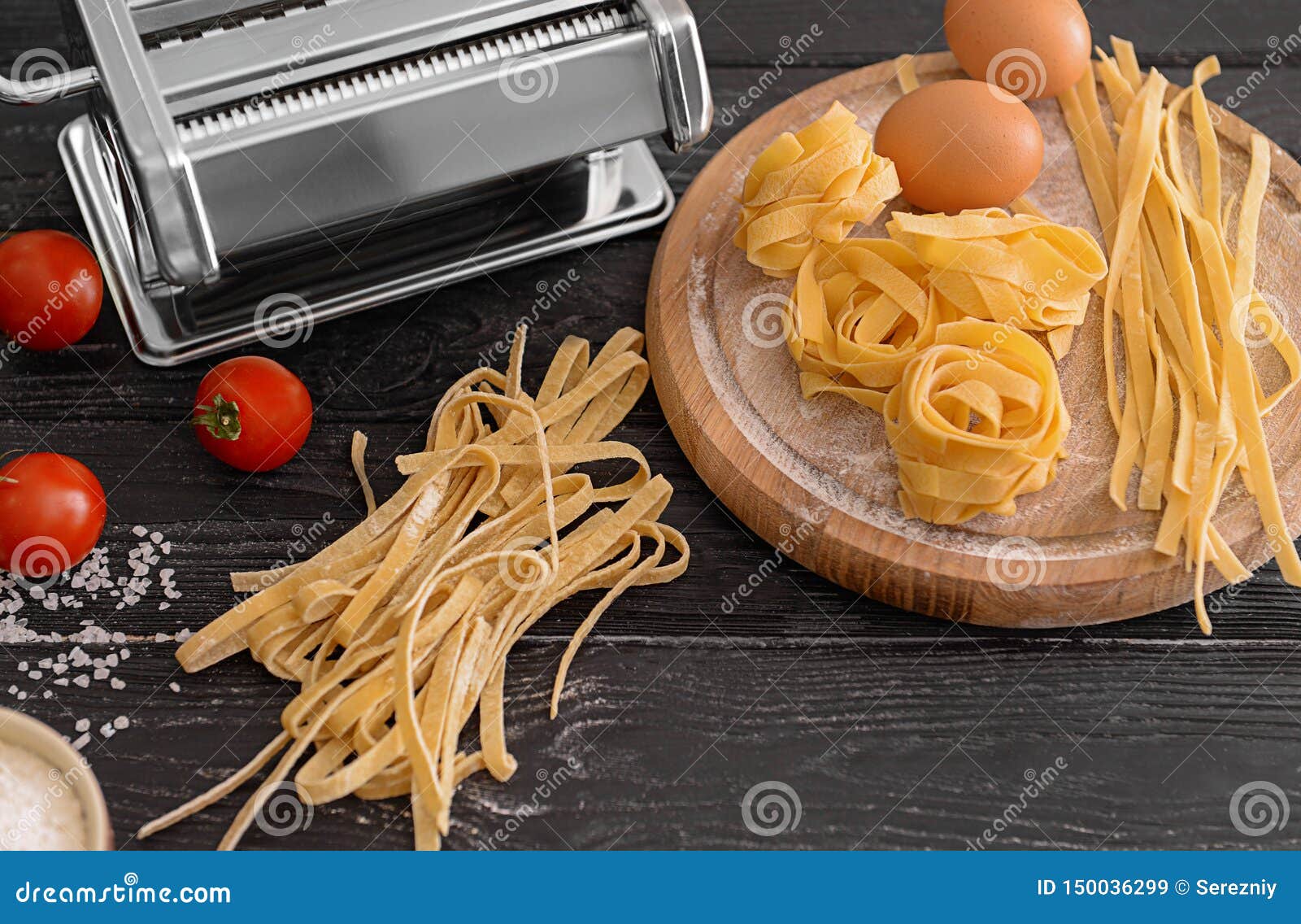 Composition with Homemade Noodles and Pasta Machine on Table Stock