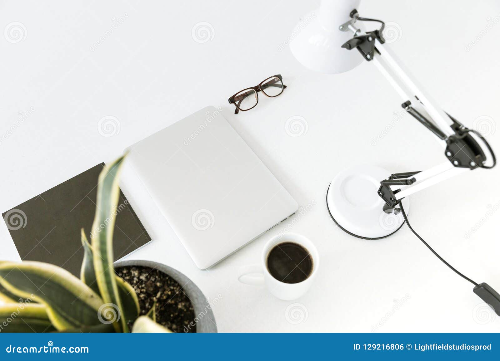 composition with laptop, desklamp and glasses