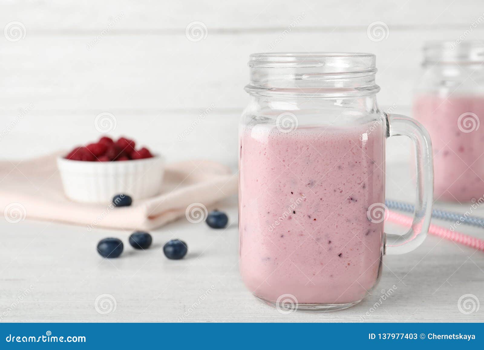Composition with Mason Jar of Healthy Protein Shake on Table. Stock