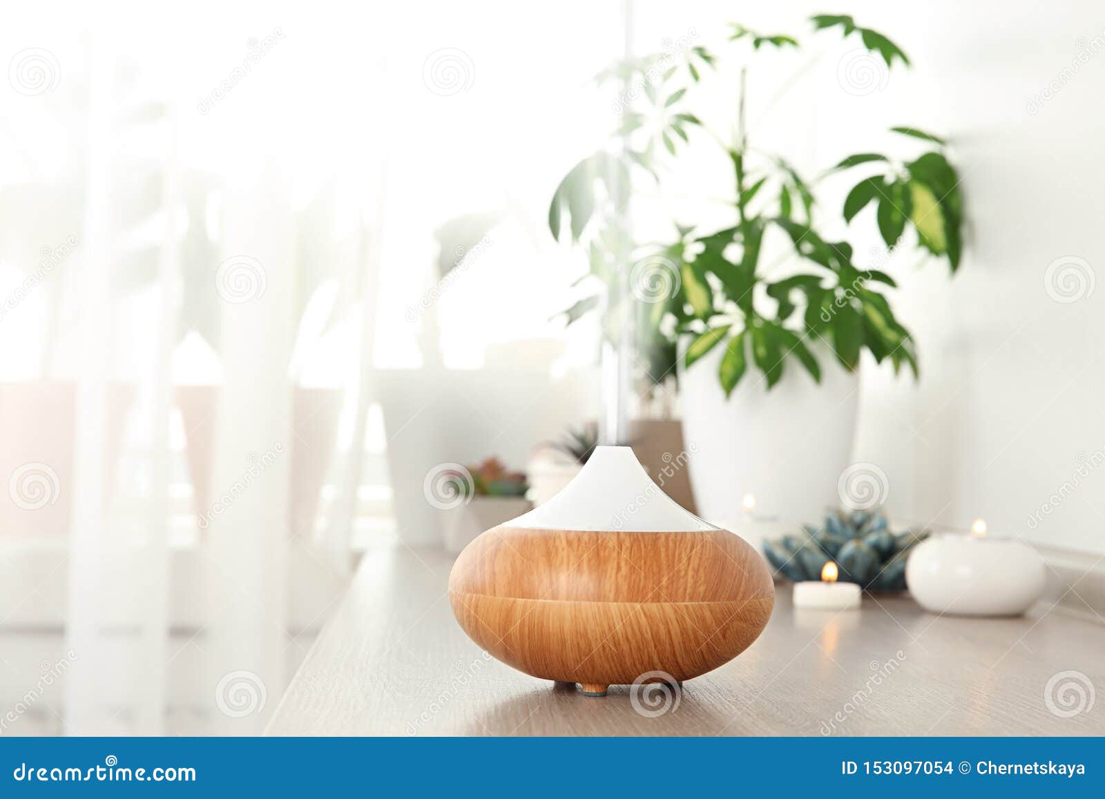 composition with modern essential oil diffuser on wooden shelf indoors