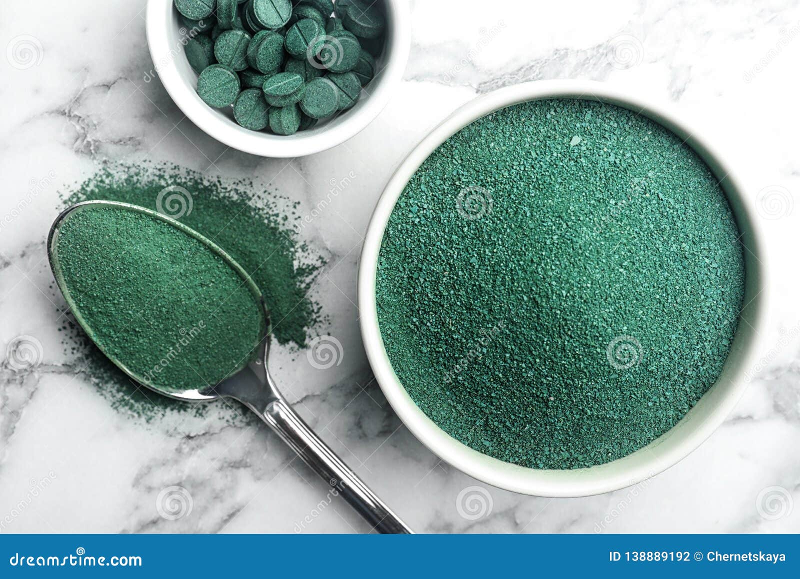 Composition With Spirulina Algae Powder And Pills On Marble Background