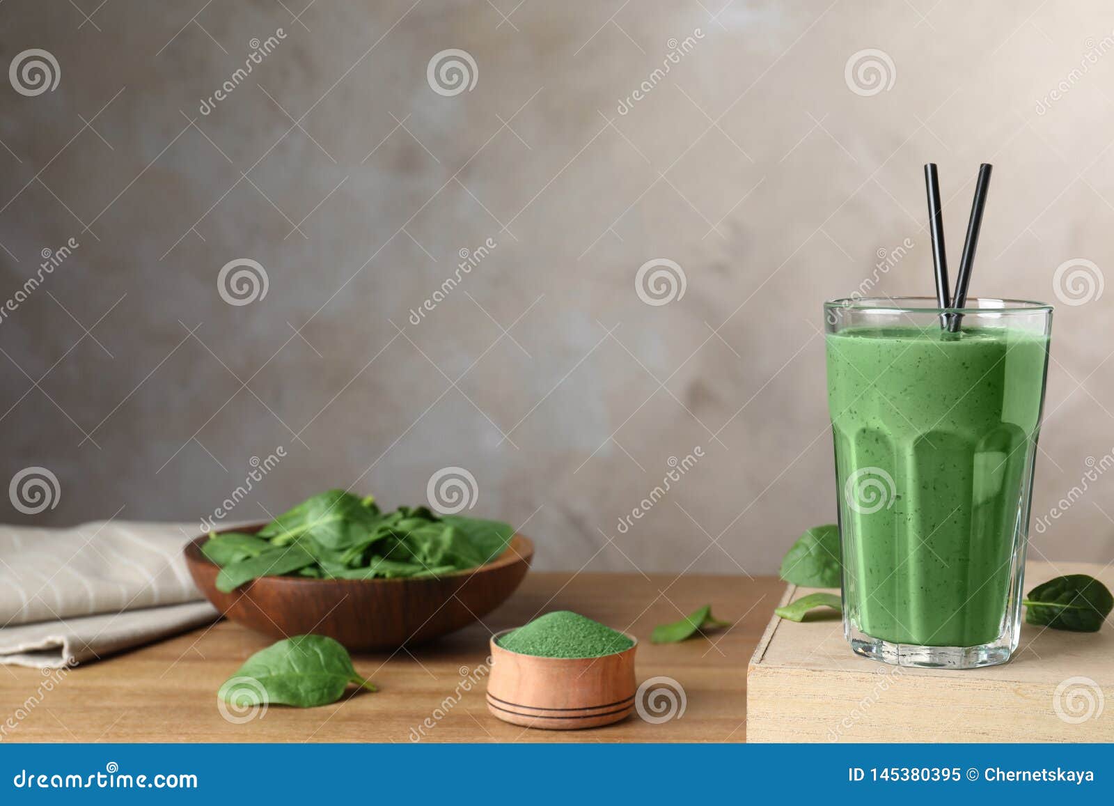 Composition with Spirulina Smoothie, Powder and Spinach on Table. Stock