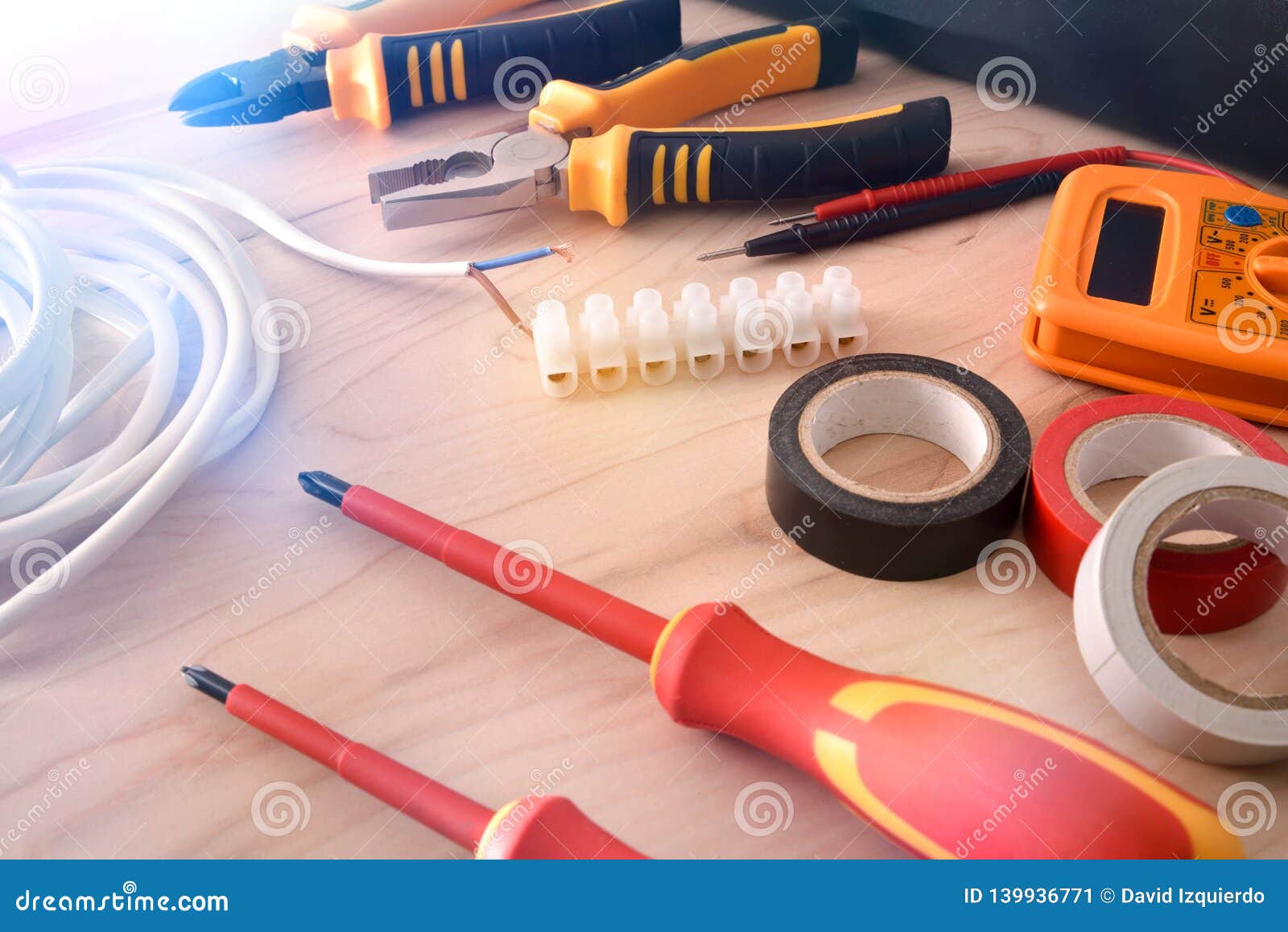 composition of tools for electrical repairs on wooden table elevated