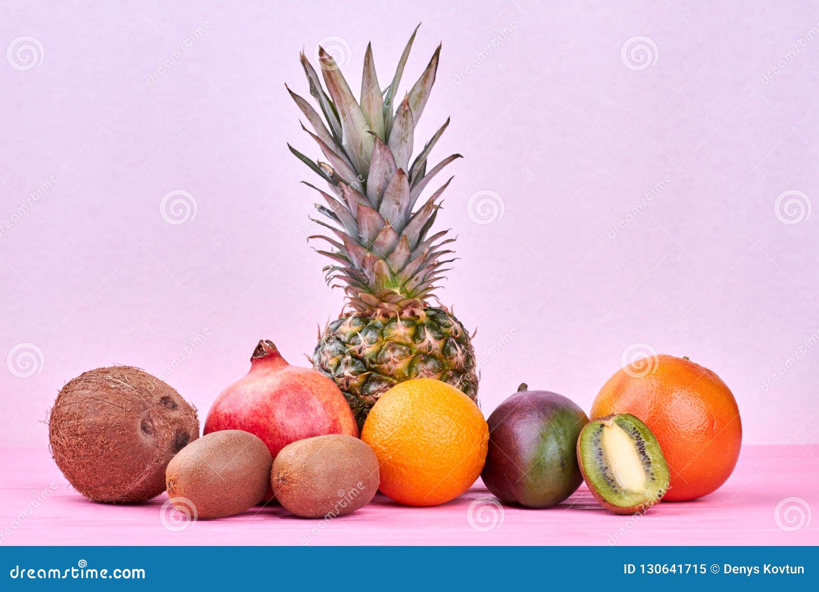 Composition from Tropical Fruits on Pink Background. Stock Image