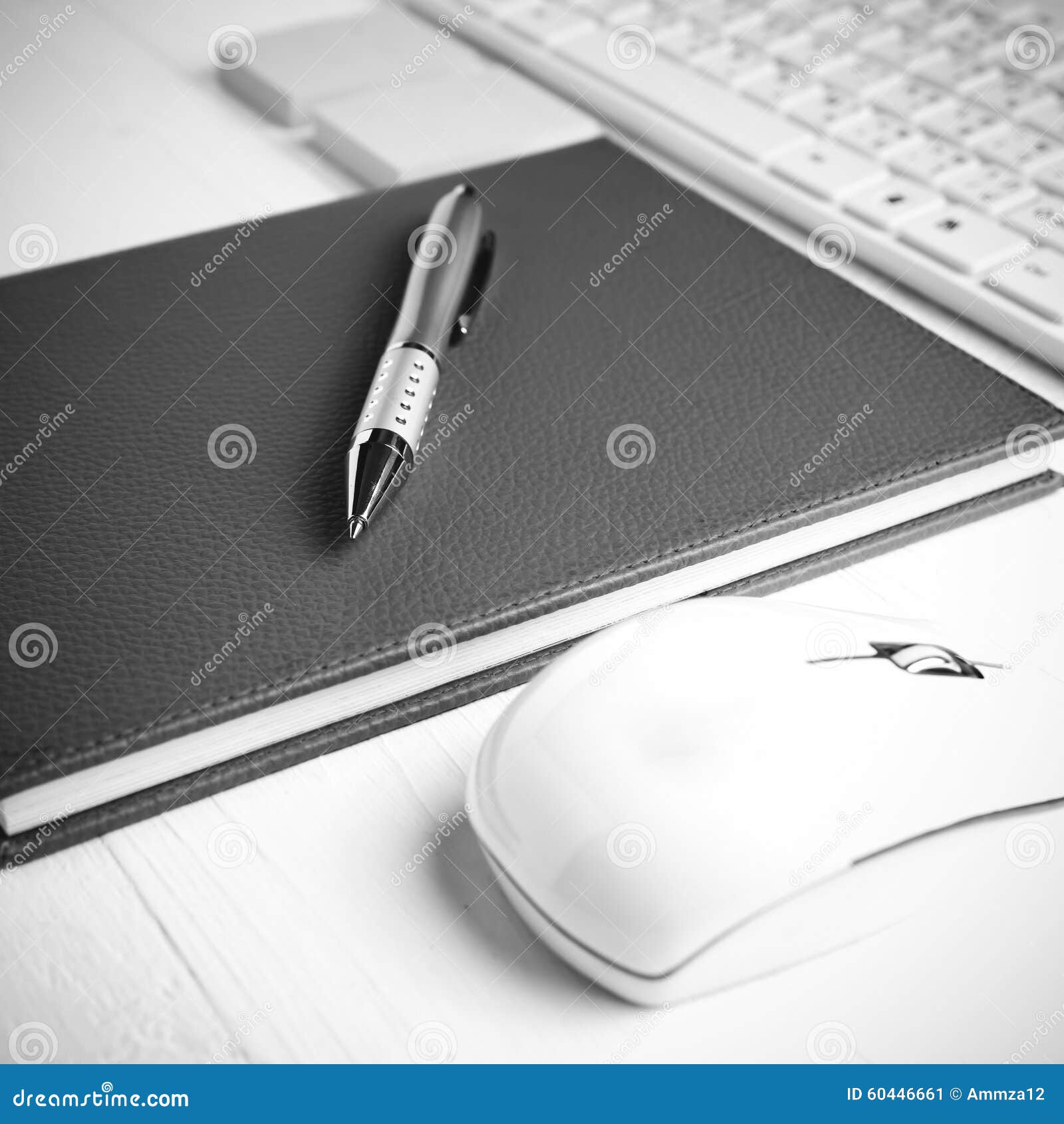 Computer and Brown Notebook with Office Supplies Black and White Stock