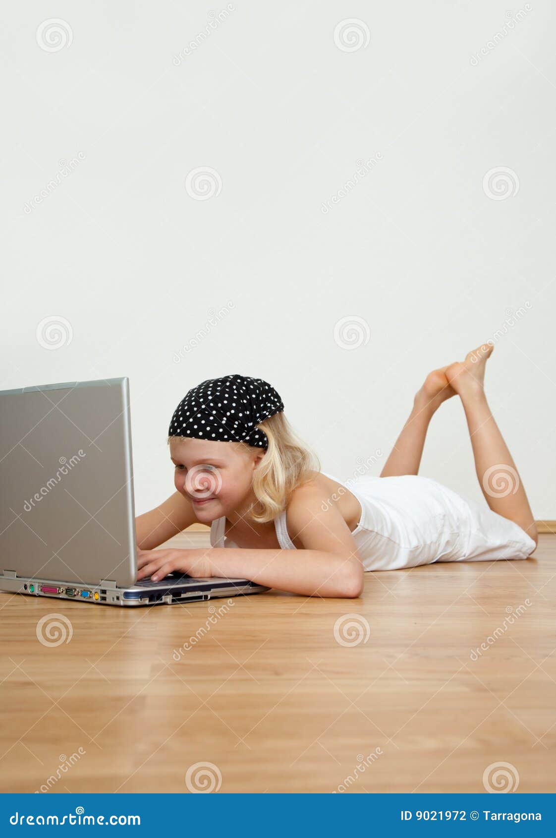 Computer kids. Little blonde girly sitting on the floor with modern computer