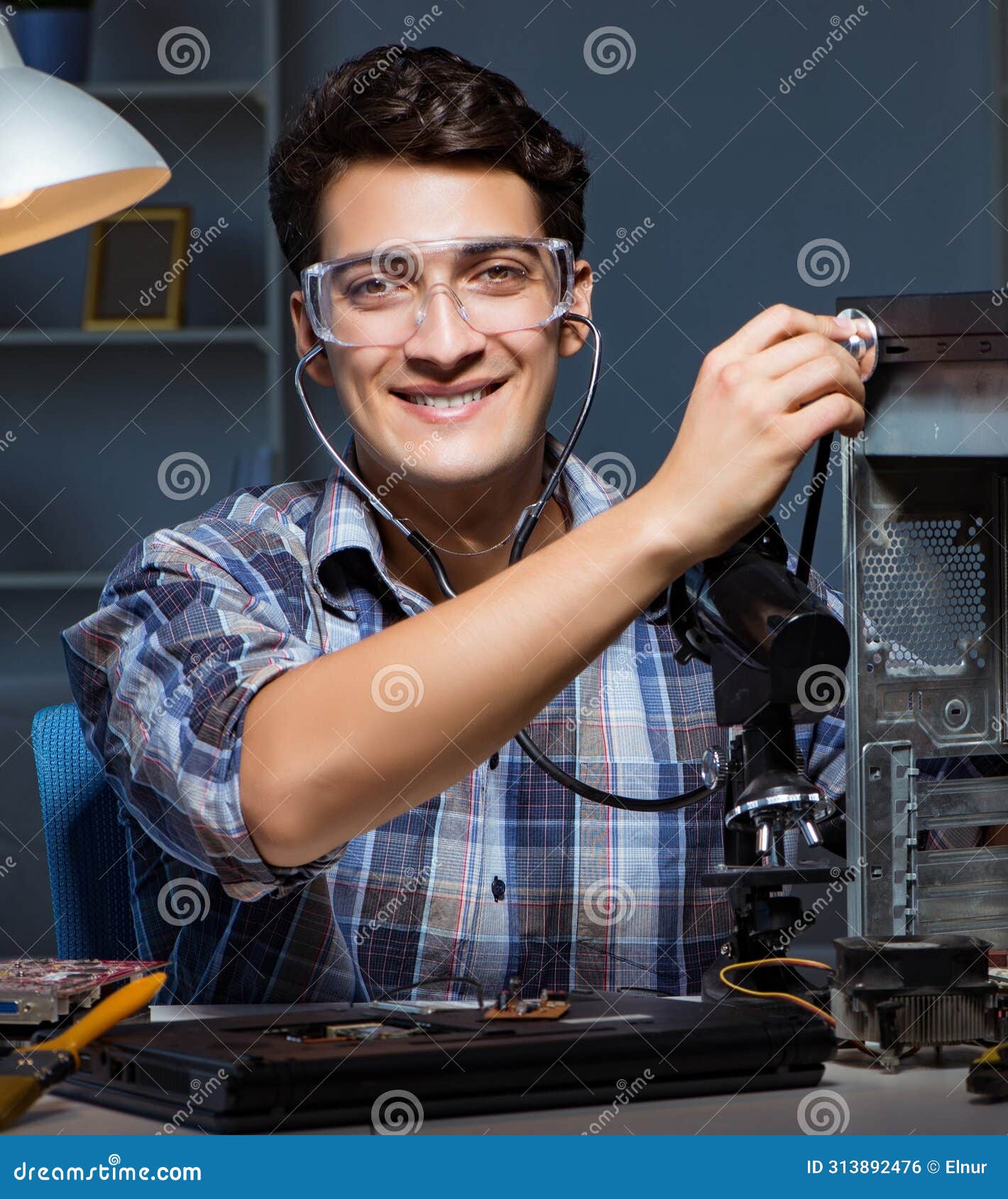 The Computer Repair Concept with Man Inspecting with Stethoscope Stock