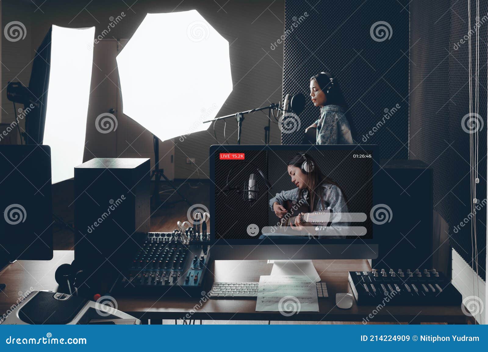 the computer screen at the control desk recording the singer`s voice was broadcasting live. there is a recording device placed on