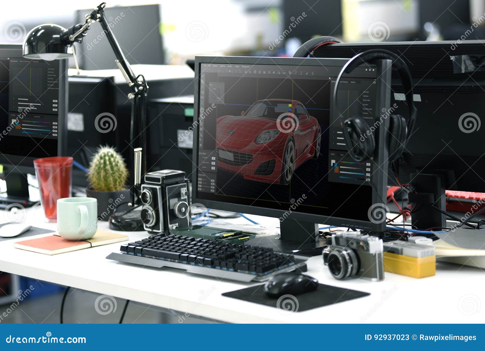 Computer Screen Showing Graphic Car Design on Office Table Working