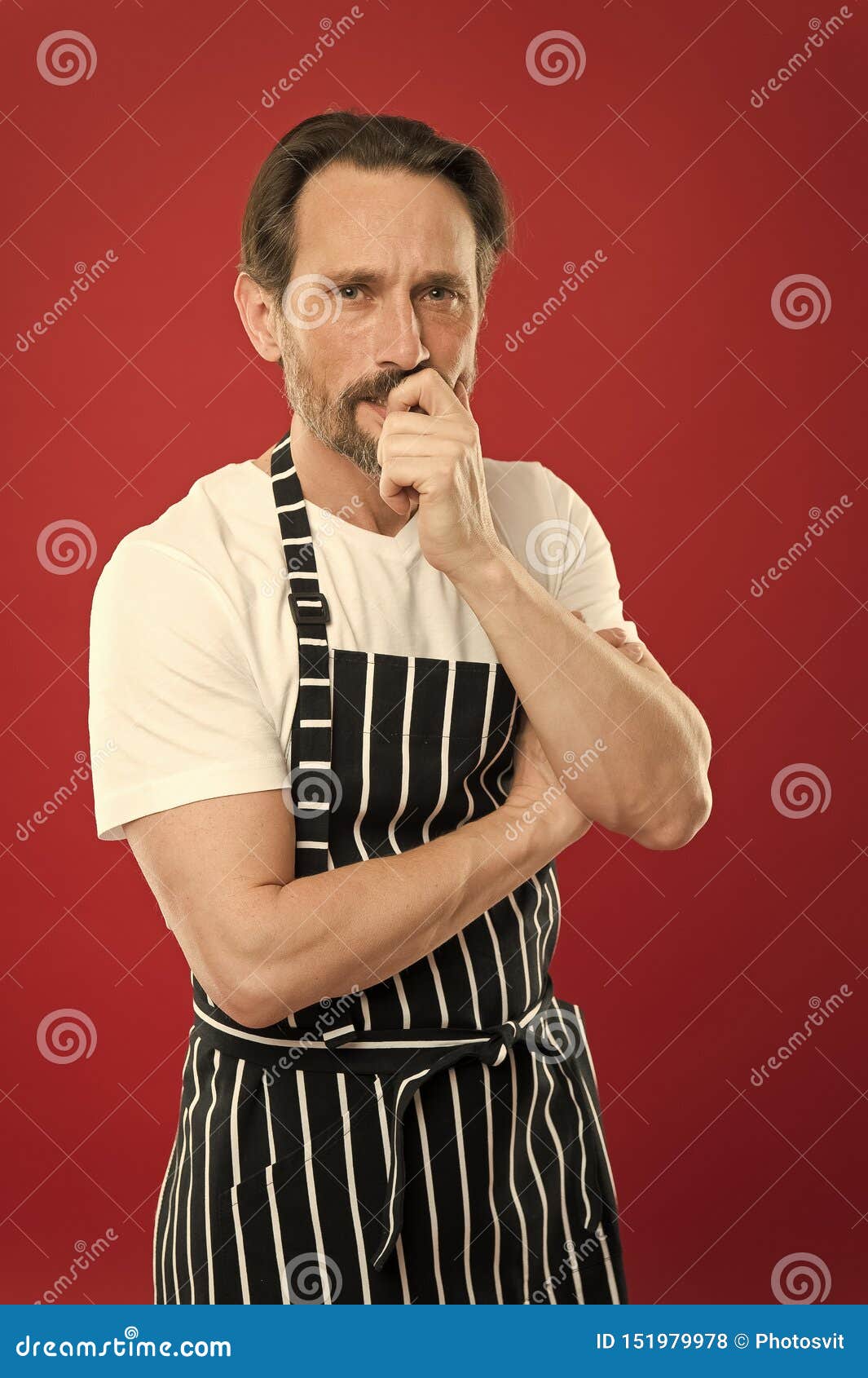 Concentrated On The Task Doing Household Bearded Mature Man In Striped Apron Senior Cook 