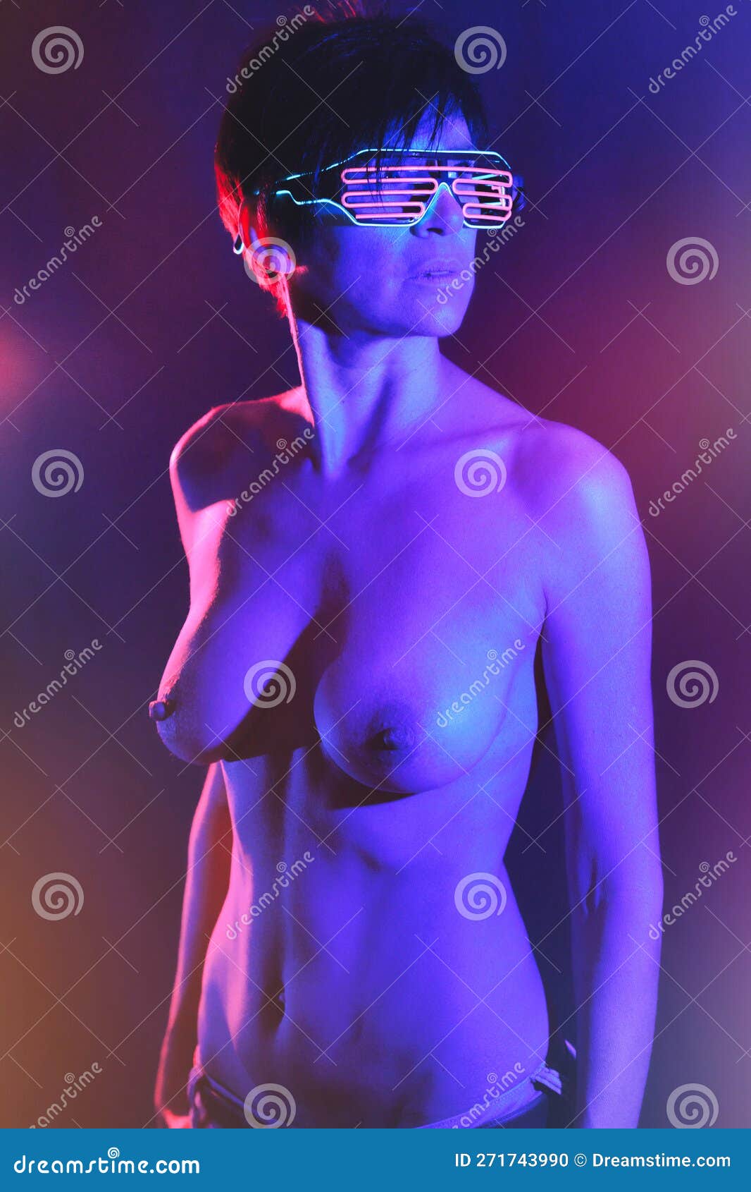Naked Woman in Shutter Glasses Standing in Neon Lights Stock Photo