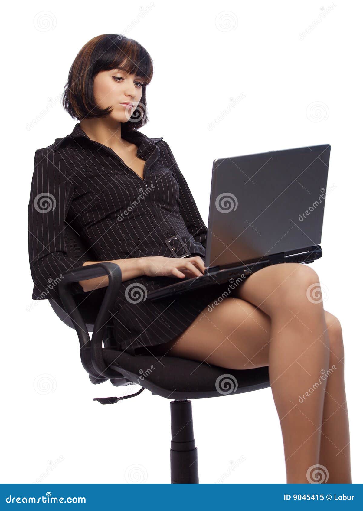 concentrated brunette woman in dark dress sitting