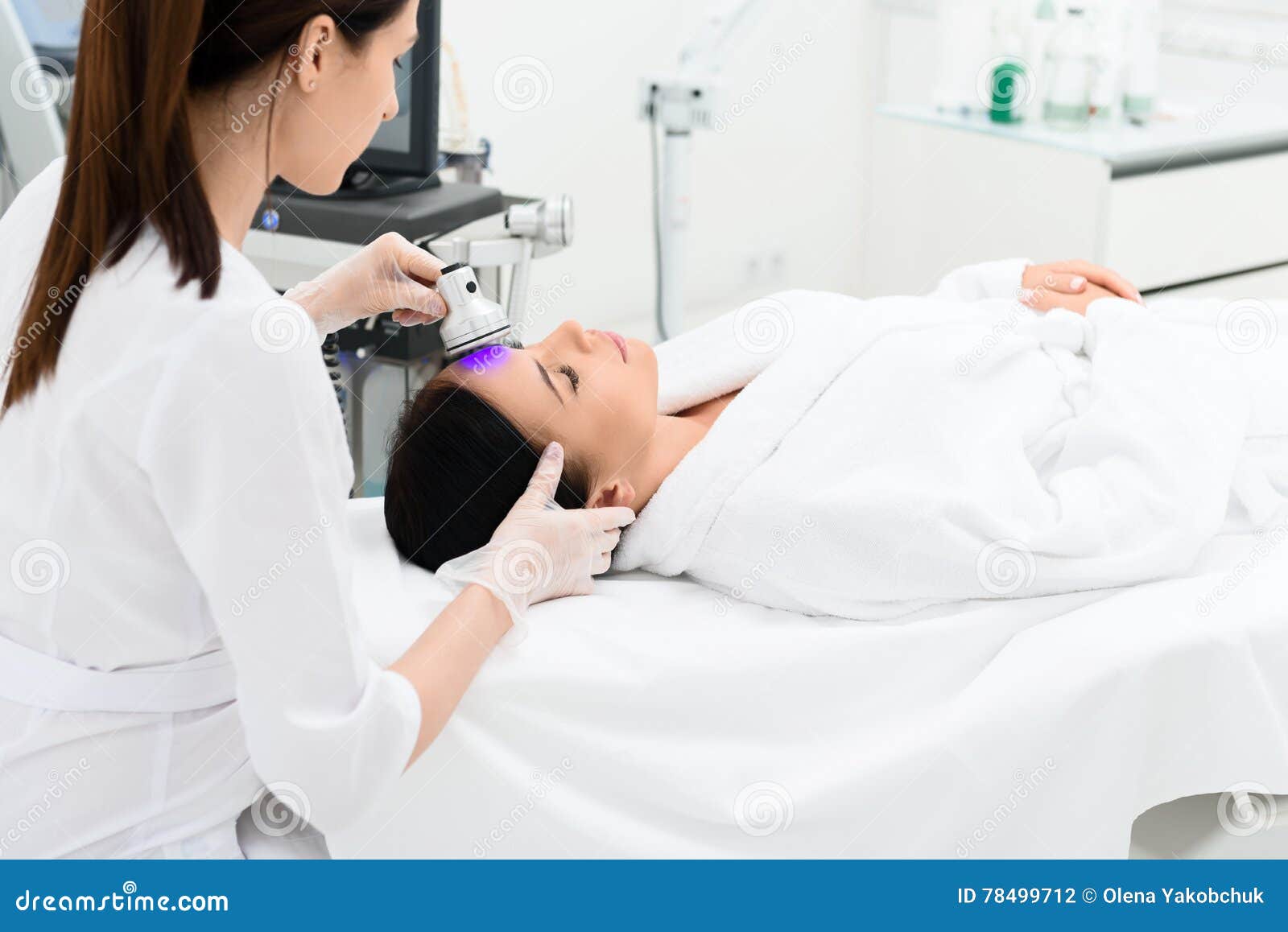 Concentrated Cosmetologist Doing Skin Care Treatment Stock Photo