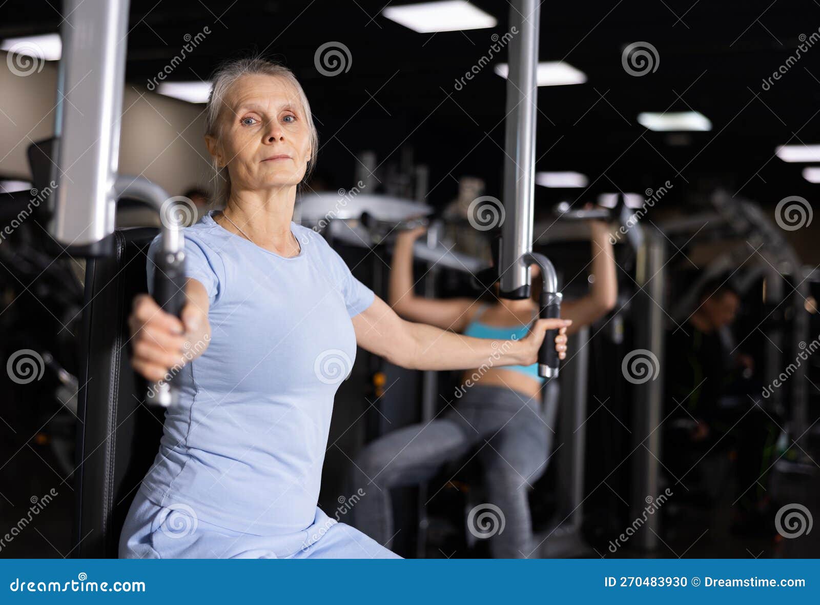 Elderly Woman Exercising Chest Muscles on Butterfly Machine Stock Photo -  Image of exercising, leisure: 270483930