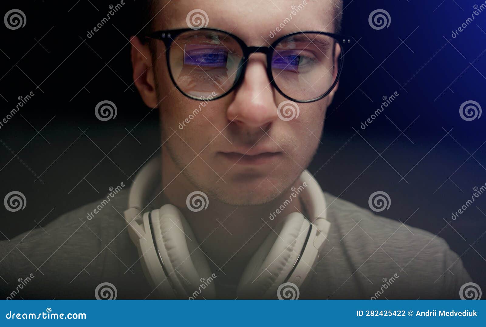 Concentrated Young Professional Programmer in Computer Glasses with