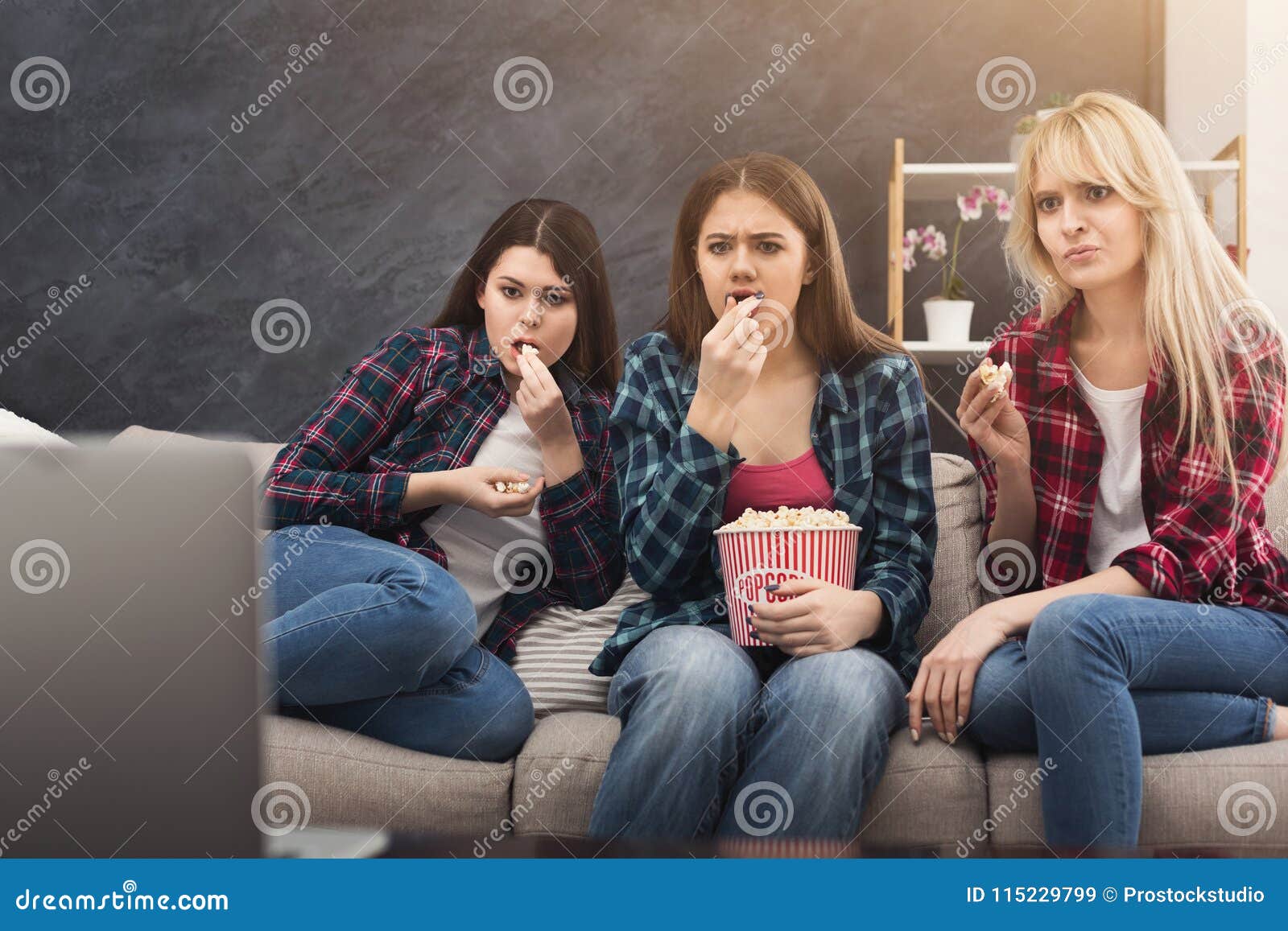 Concentrated Young Women Watching Movie At Home Stoc