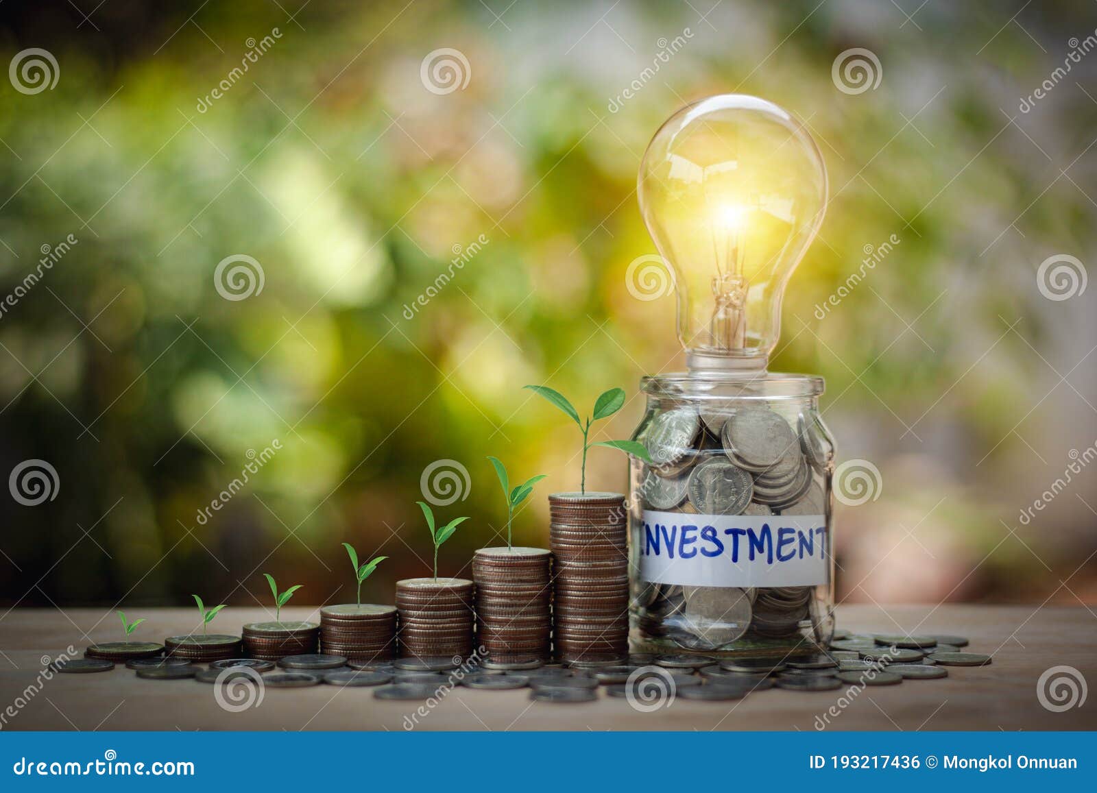 concept of business with lightbulb and coins stacking saving money concept preset by tree on the top coins stack