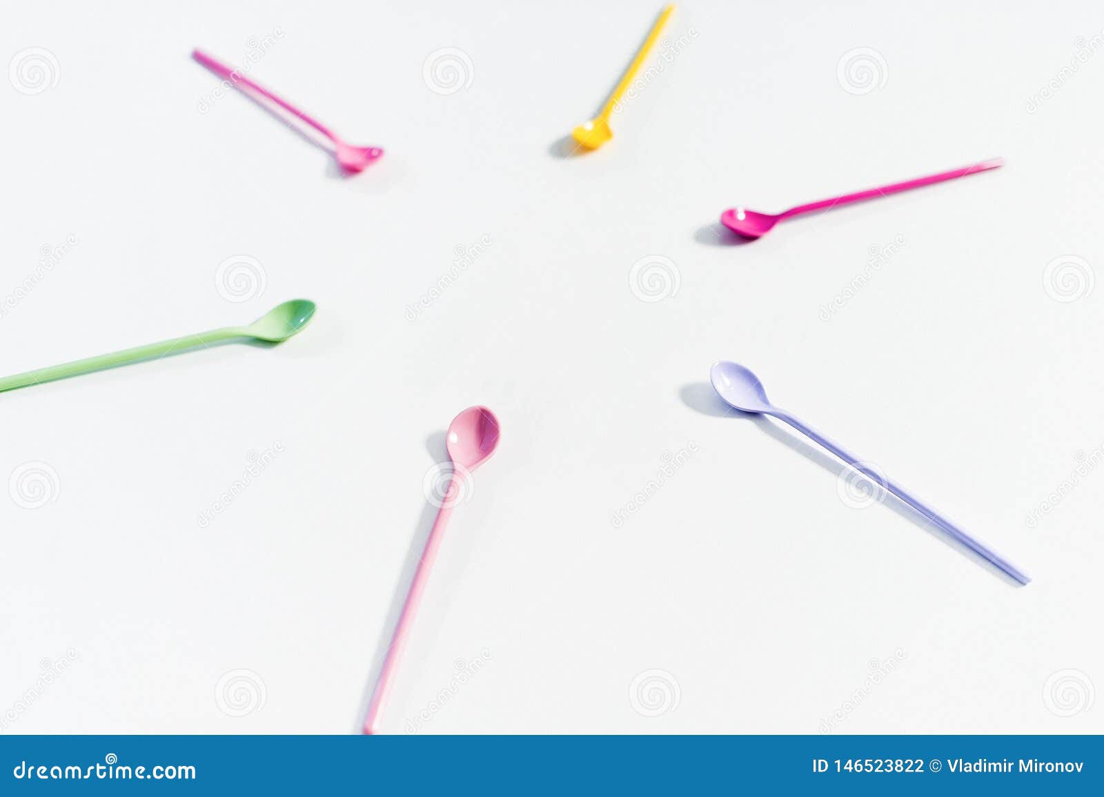 The Concept of Coloured Dessert Spoons on White Background. Stock Photo Image of background