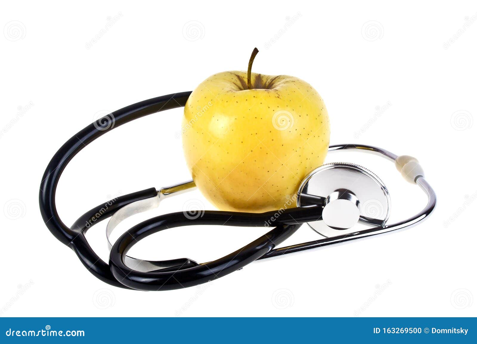 concept for diet and healthcare - yellow apple and stetoskop on a white background