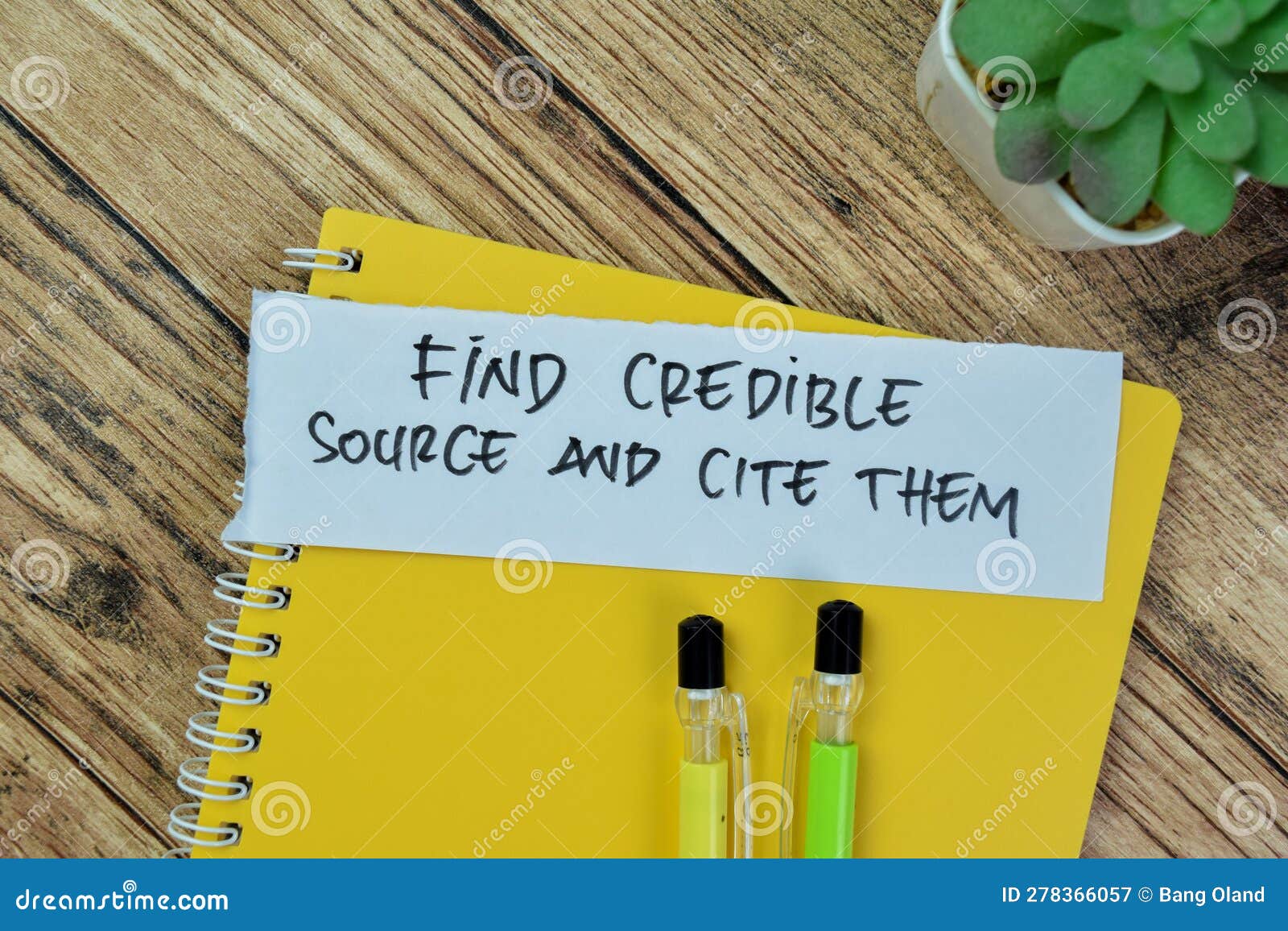 concept of find credible source and cite them write on sticky notes  on wooden table