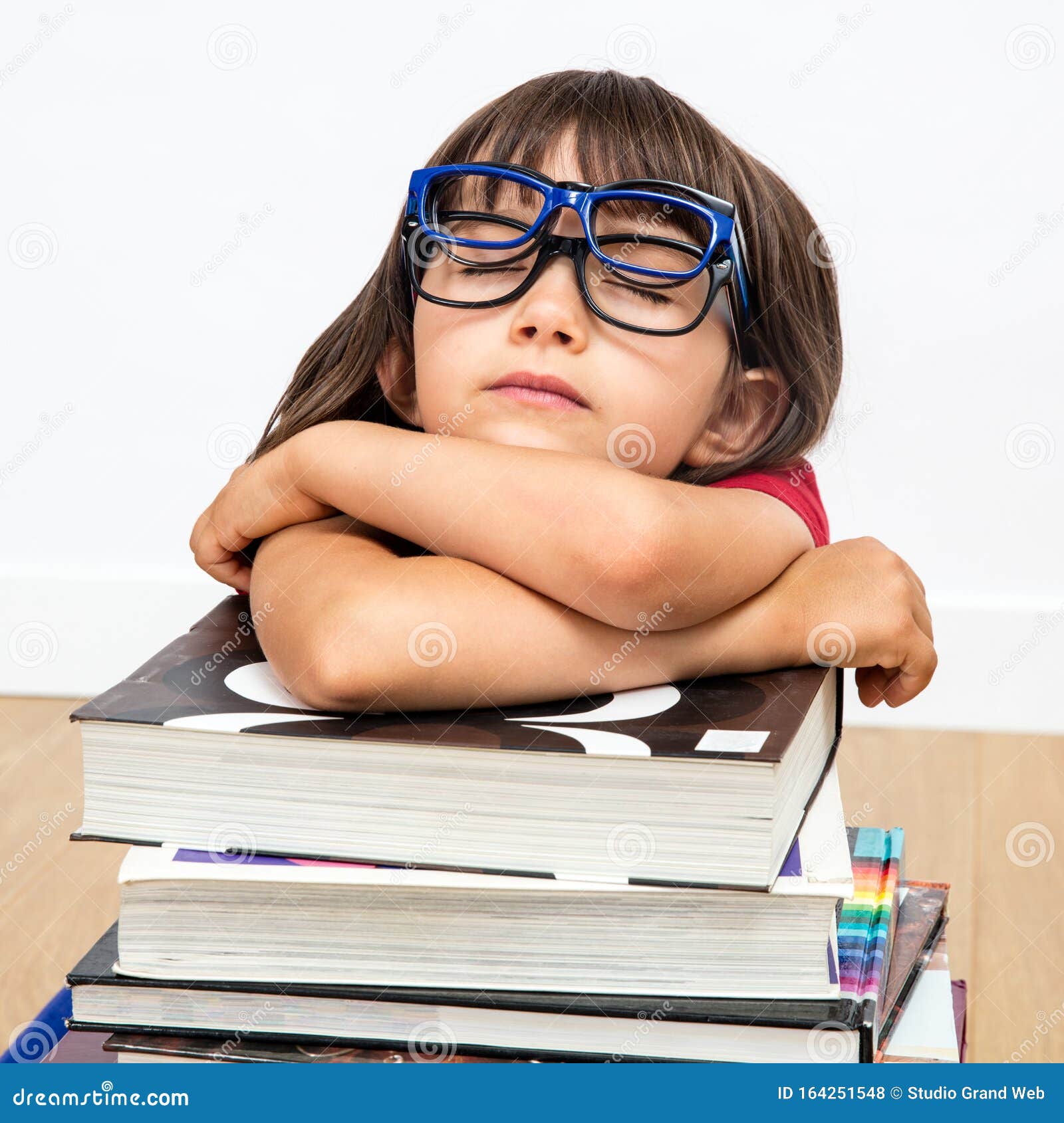 concept of happy gifted child with eyeglasses sleeping, white background