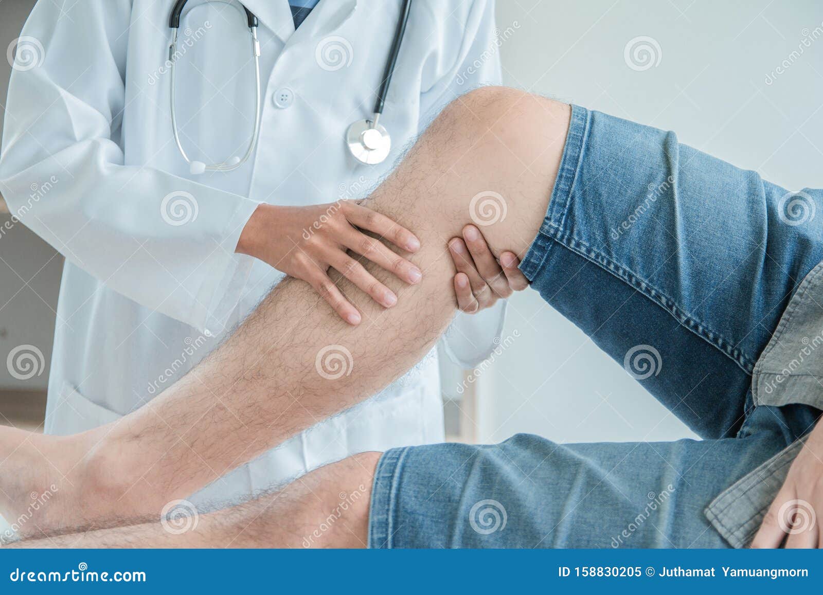 concept healthy ,male patient in blue shirt visiting doctor of orthopedics examining injured leg and knee of male patient