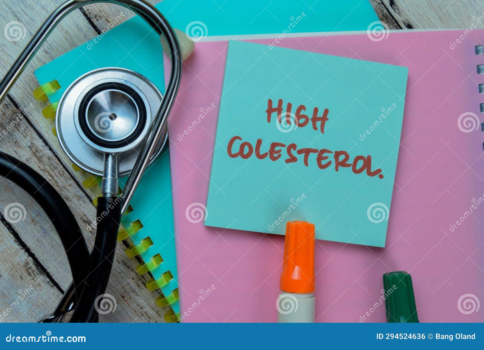 concept of high colesterol write on sticky notes with stethoscope  on wooden table