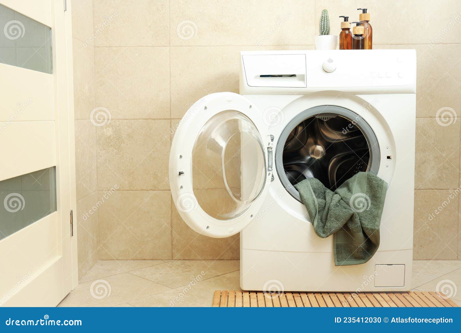 Concept of Housework with Washing Machine in Bathroom Stock Photo