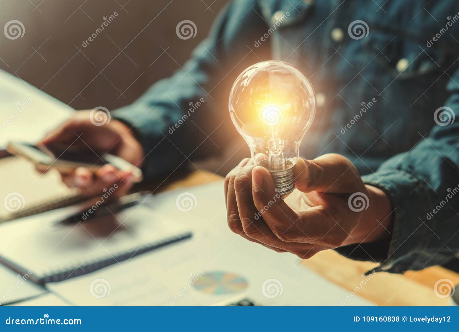 concept idea saving energy. businessman hand holding lightbulb i