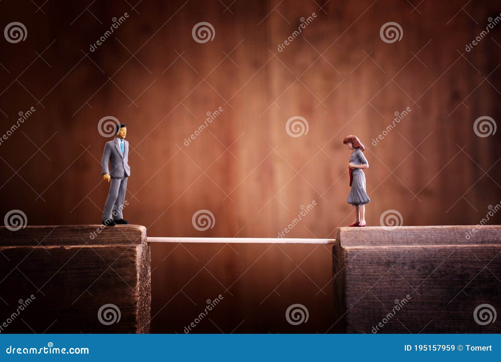 concept image of bridging the gap. a man has to cross a thin rope to reach his partner who is on the other side
