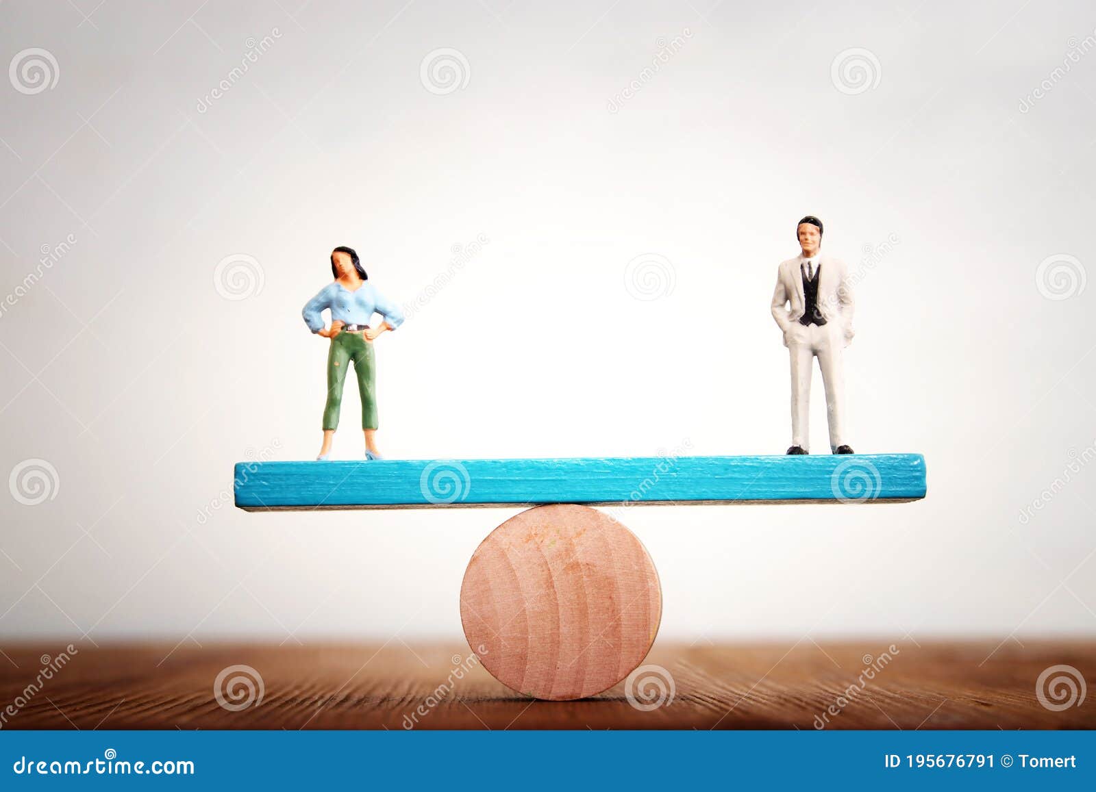 concept image of gender equality. man and woman balancing on seesaw