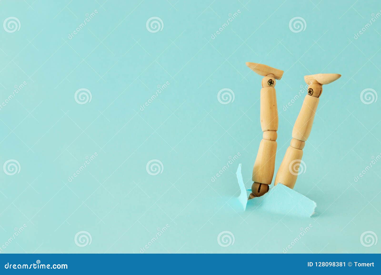 concept image of wooden dummy stuck upside down. stress and danger concept.