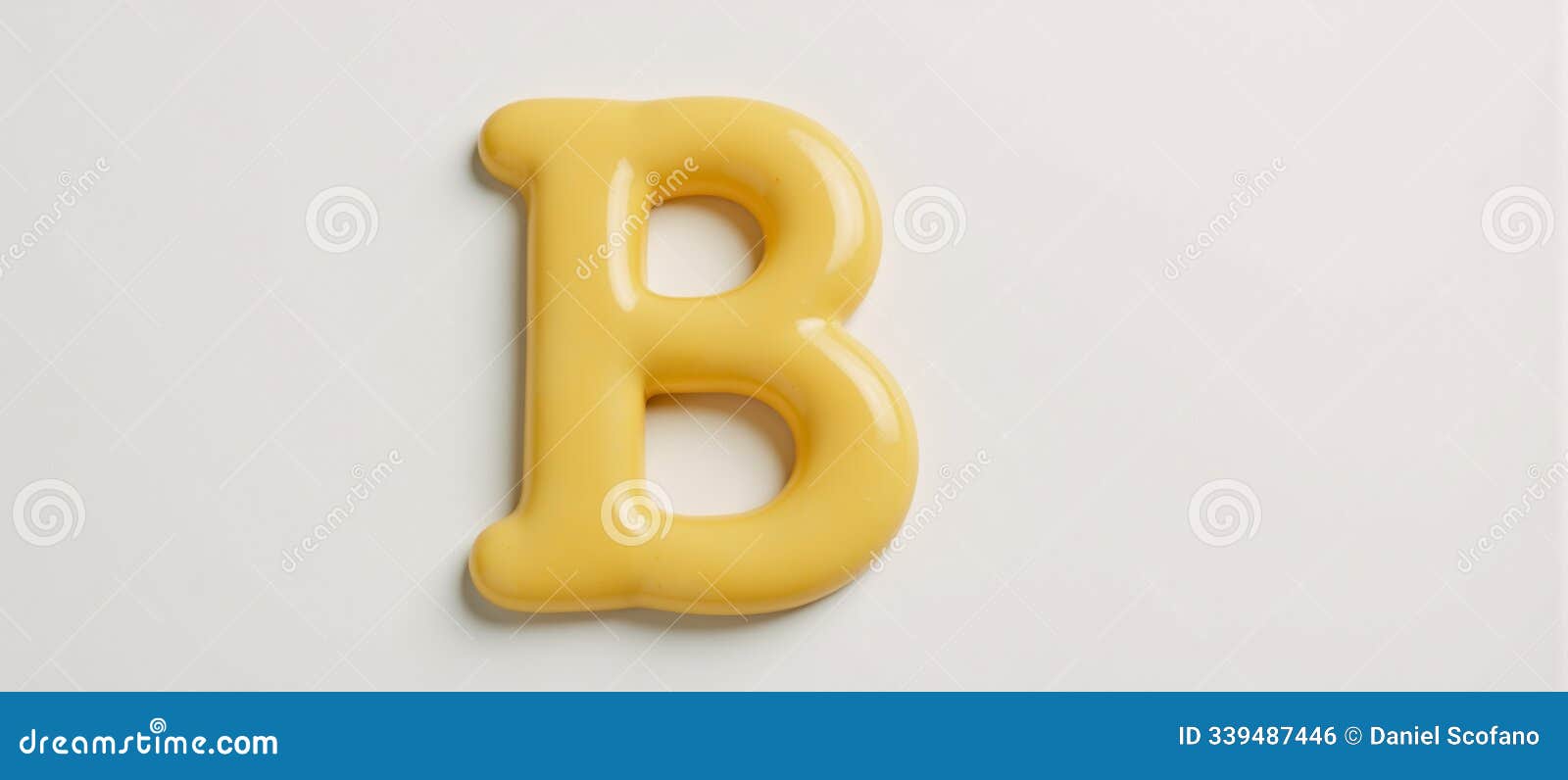  letter b crafted from melted butter against a plain background