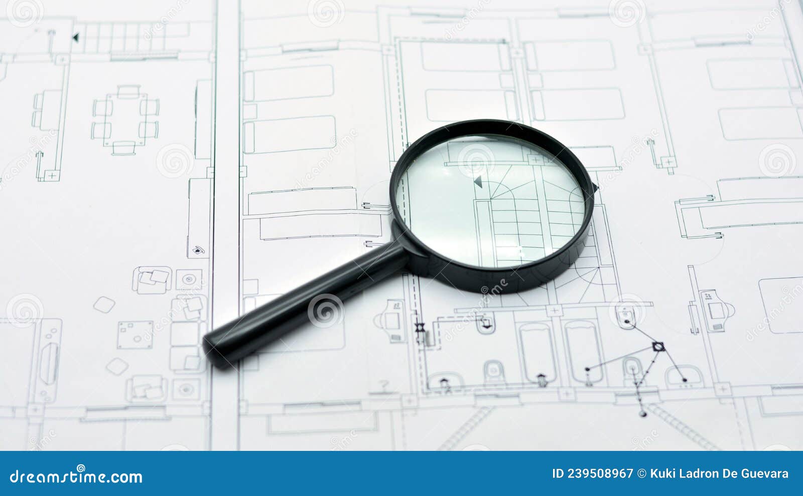 concept of looking at a blueprint with a magnifying glass