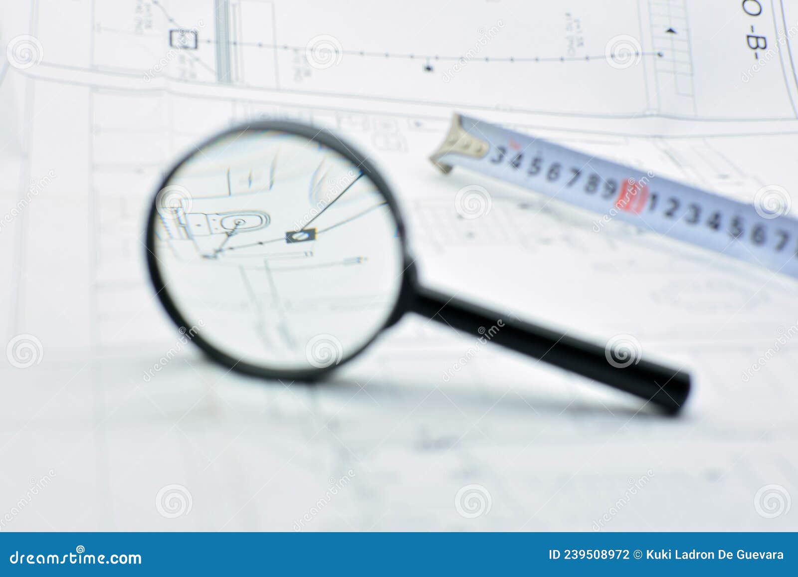 concept of looking at a blueprint with a magnifying glass