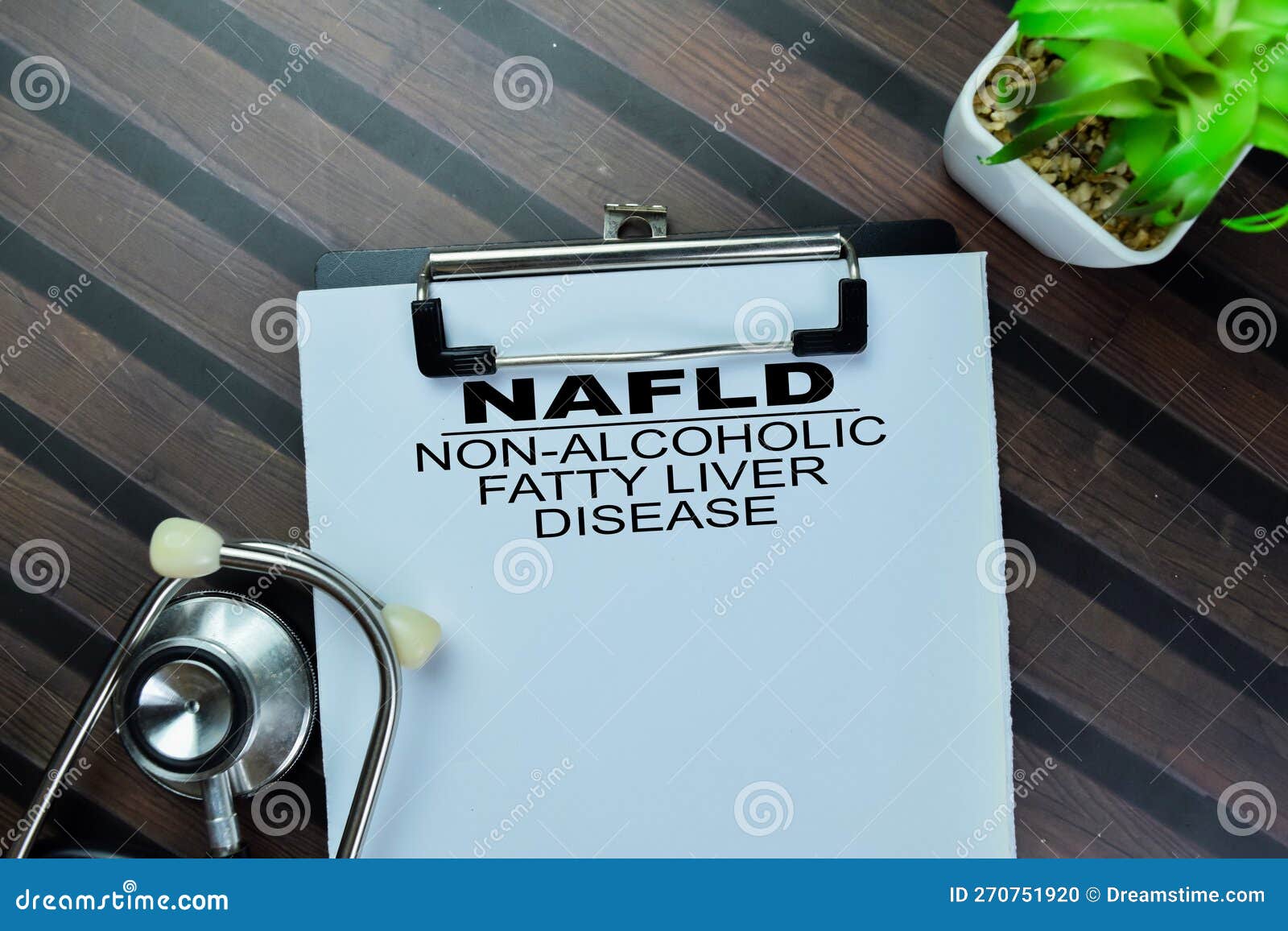 concept of nafld - non-alcoholic fatty liver disease write on paperwork with stethoscope  on wooden table