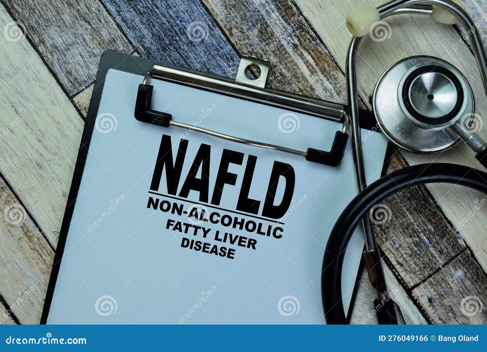 concept of nafld - non-alcoholic fatty liver disease write on paperwork with stethoscope  on wooden table