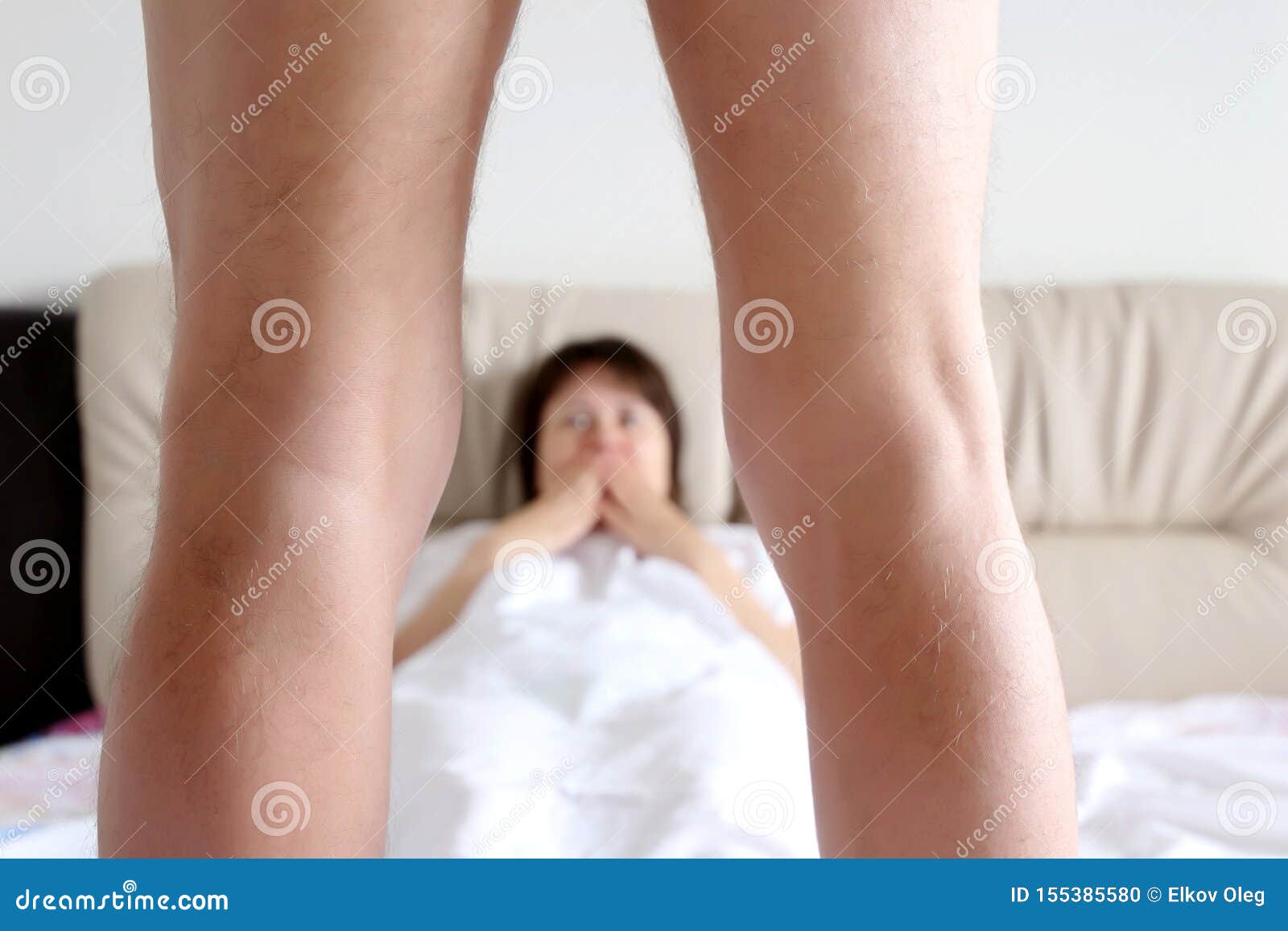Couple of Lovers in a Bed, Surprised Woman Looking on Naked Man Stock Photo 