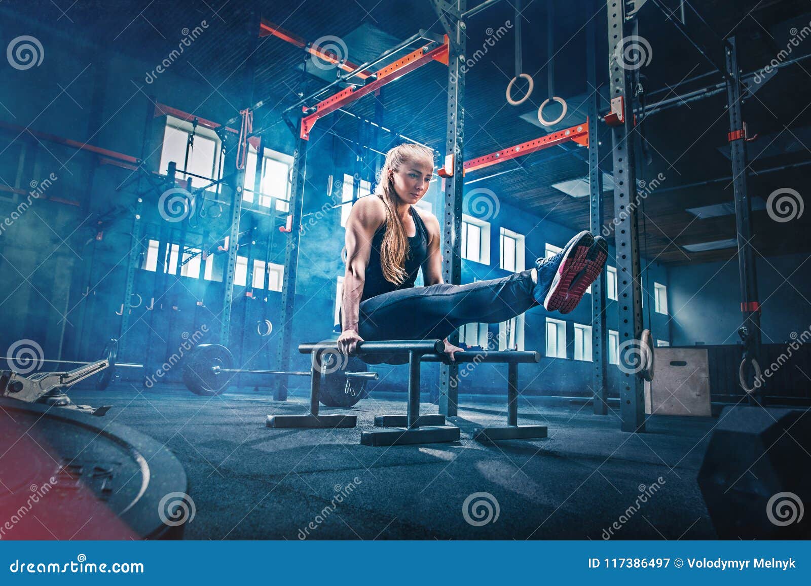 concept: power, strength, healthy lifestyle, sport. powerful attractive muscular woman at crossfit gym