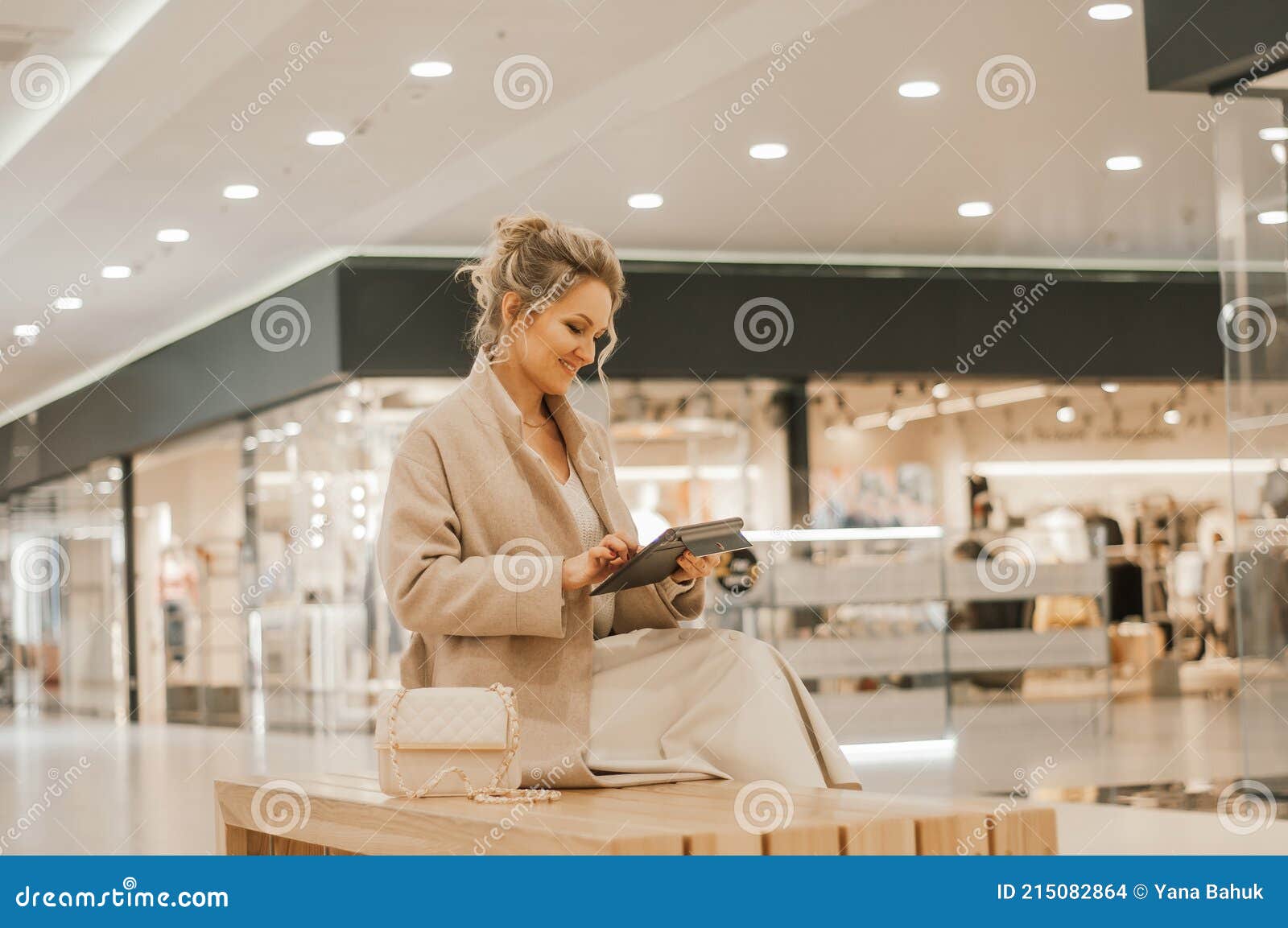 the concept of protection from coronavirus while shopping. a young girl makes an online purchase through a tablet