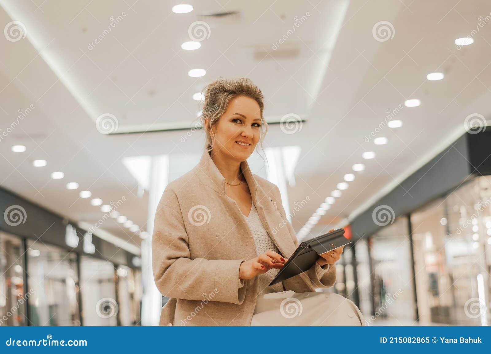 the concept of protection from coronavirus while shopping. a young girl makes an online purchase through a tablet